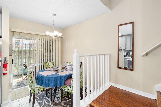 dining room featuring light tile patterned flooring and a chandelier