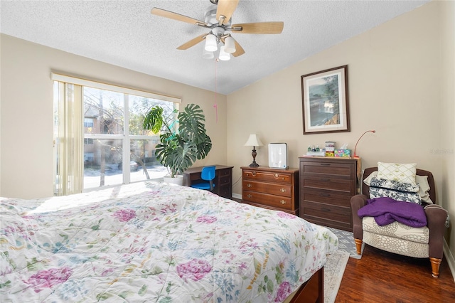 bedroom featuring lofted ceiling, dark wood-type flooring, ceiling fan, a textured ceiling, and access to outside