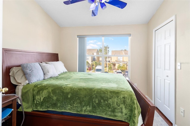 bedroom with ceiling fan, wood-type flooring, and a closet