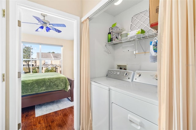 clothes washing area with ceiling fan, dark hardwood / wood-style floors, and washer and dryer