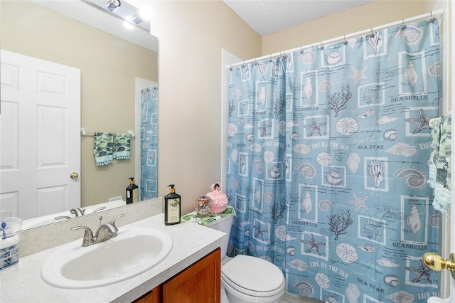 bathroom with vanity, a shower with curtain, toilet, and a textured ceiling