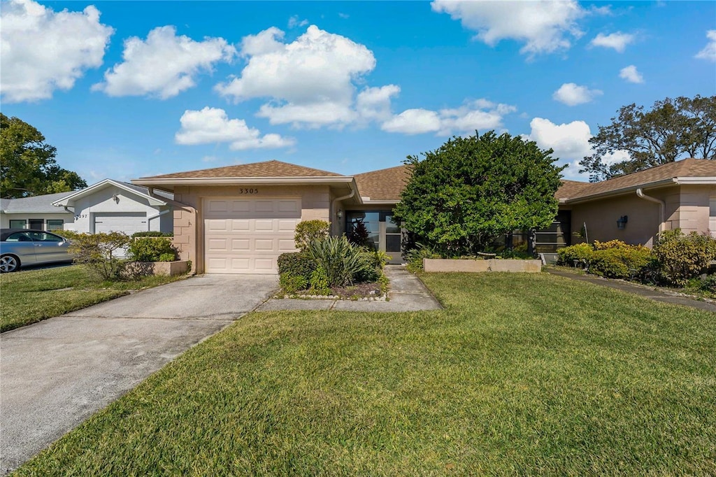 view of front facade featuring a garage and a front lawn