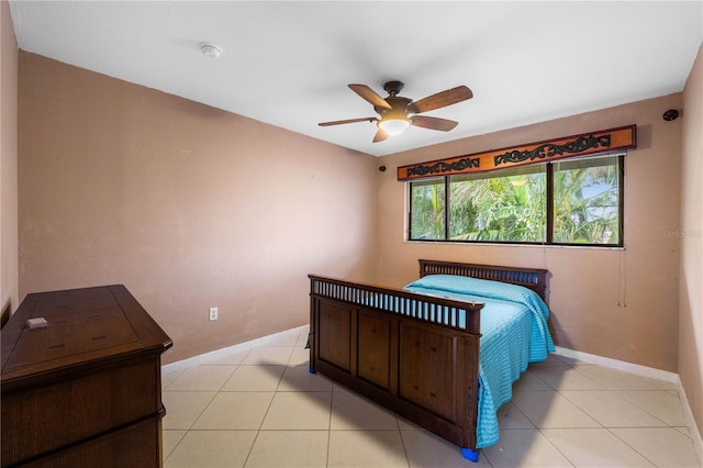 tiled bedroom with ceiling fan