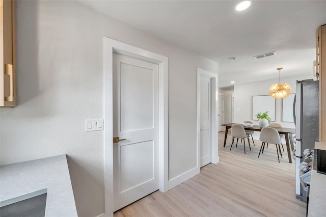 hall featuring recessed lighting, visible vents, light wood-style flooring, and baseboards