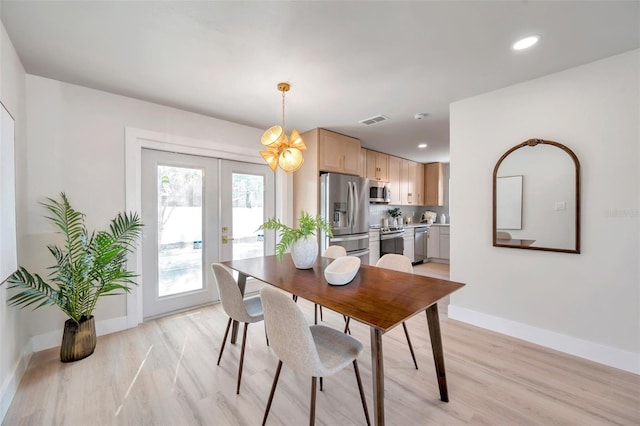 dining space with french doors, visible vents, baseboards, and light wood finished floors