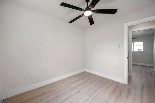 unfurnished room with light wood-style flooring and baseboards