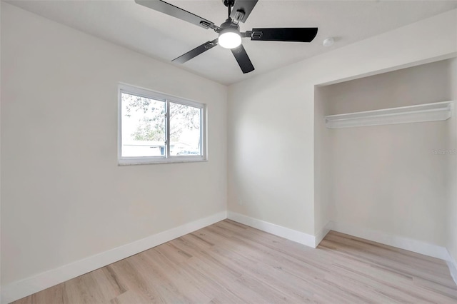 unfurnished bedroom with a ceiling fan, light wood-type flooring, and baseboards