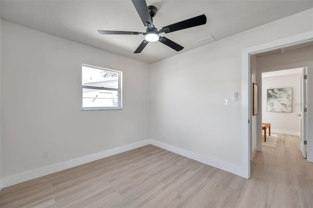 unfurnished room featuring light wood finished floors, baseboards, visible vents, and ceiling fan