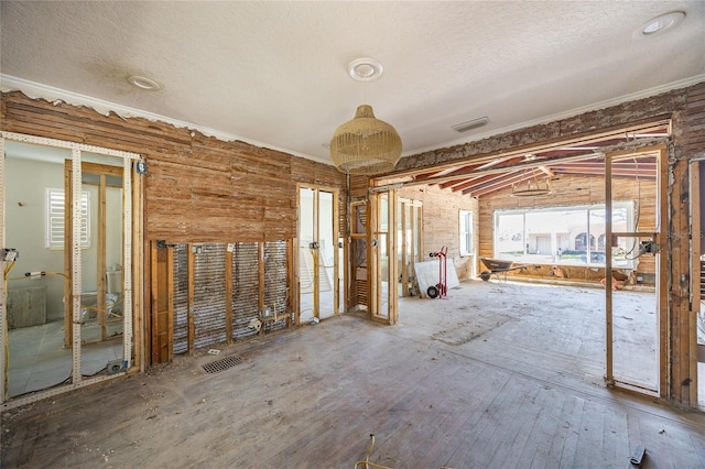 miscellaneous room with ornamental molding and a textured ceiling