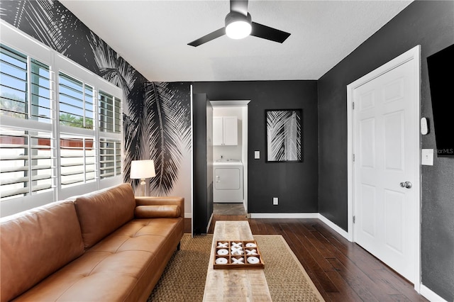 living room featuring washer / clothes dryer, dark hardwood / wood-style floors, and ceiling fan