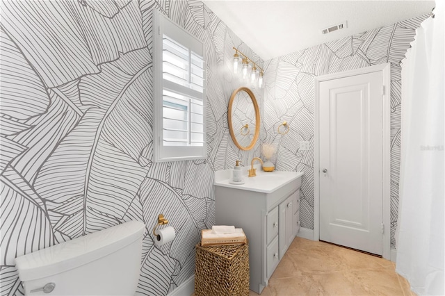 bathroom with vanity, toilet, and tile patterned flooring