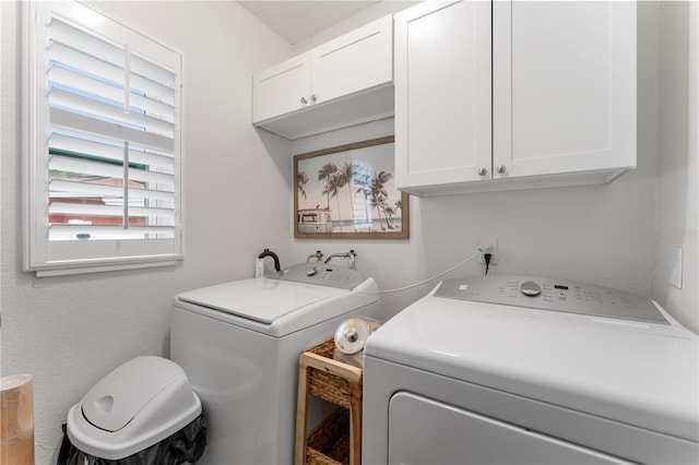 laundry area with cabinets and washing machine and clothes dryer