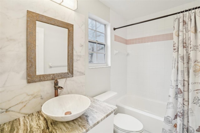 full bathroom featuring tile walls, vanity, toilet, and shower / bath combo with shower curtain