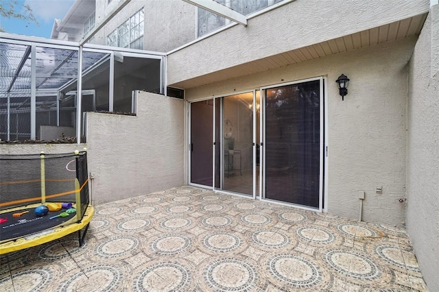 view of patio / terrace featuring glass enclosure