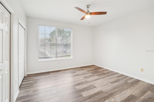 2794 Countryside Blvd Unit 1, Clearwater, FL 33761 - unfurnished bedroom with wood finished floors and a ceiling fan