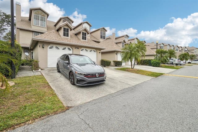 2794 Countryside Blvd Unit 1, Clearwater, FL 33761 - view of front of house with concrete driveway, stucco siding, roof with shingles, and a residential view