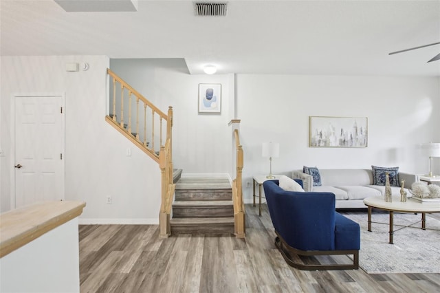 2794 Countryside Blvd Unit 1, Clearwater, FL 33761 - living area featuring wood finished floors, stairway, and a ceiling fan