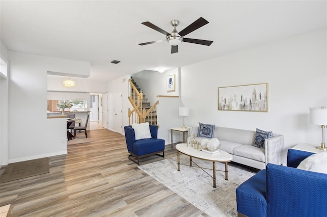 2794 Countryside Blvd Unit 1, Clearwater, FL 33761 - living room with stairs, wood finished floors, and a ceiling fan