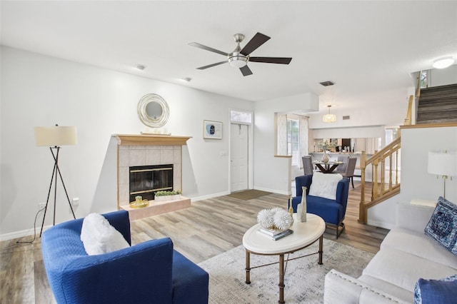 2794 Countryside Blvd Unit 1, Clearwater, FL 33761 - living area with ceiling fan, stairway, wood finished floors, and a tile fireplace