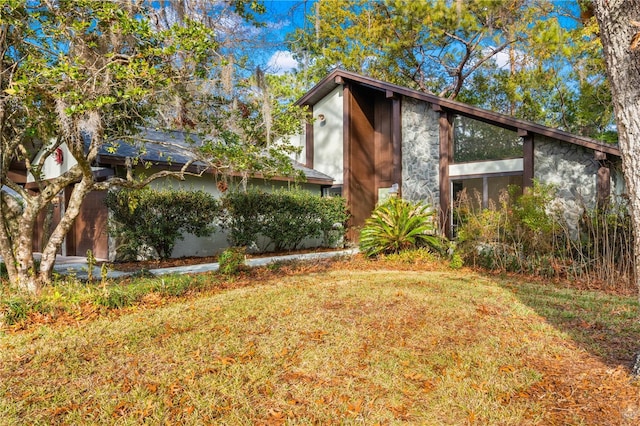 view of side of home featuring a lawn