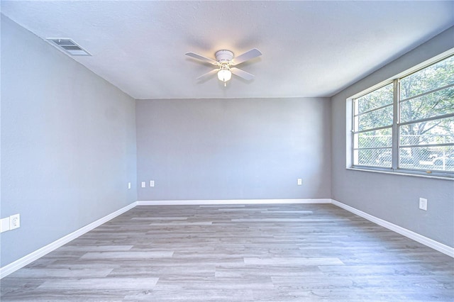 empty room with ceiling fan and wood-type flooring