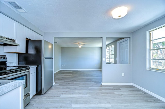 kitchen featuring a textured ceiling, light hardwood / wood-style flooring, appliances with stainless steel finishes, ceiling fan, and white cabinets