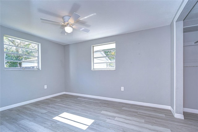 spare room with light hardwood / wood-style flooring and ceiling fan