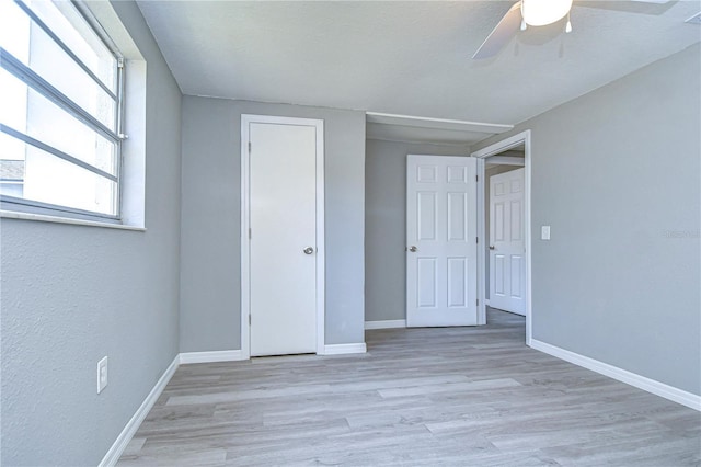 unfurnished bedroom featuring ceiling fan and light wood-type flooring