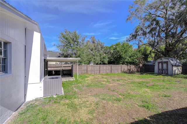 view of yard featuring central AC and a storage shed