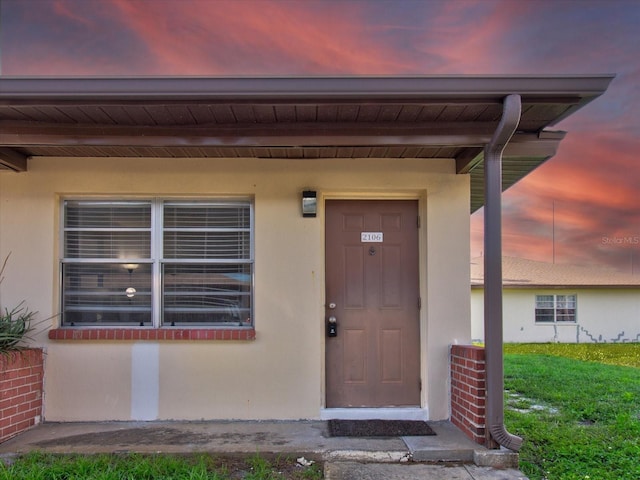 view of exterior entry at dusk