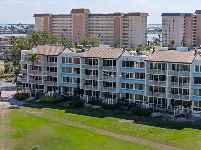 view of property with a water view and a city view