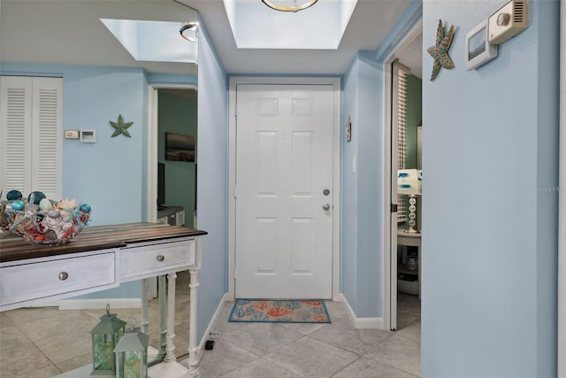 entrance foyer featuring light tile patterned flooring and baseboards