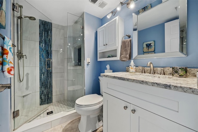 full bathroom with toilet, a stall shower, visible vents, and vanity