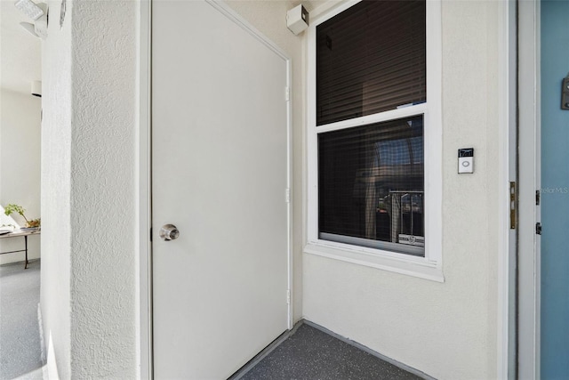 doorway to property featuring stucco siding