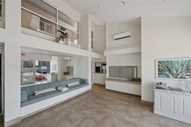 unfurnished living room featuring high vaulted ceiling, baseboards, a wall mounted air conditioner, and mail area