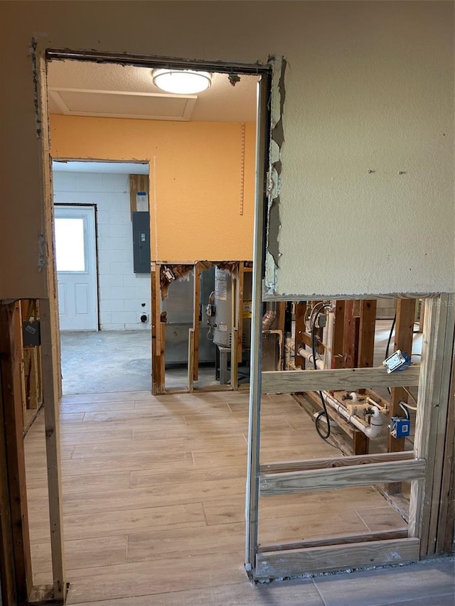 interior space featuring electric panel and light wood-type flooring