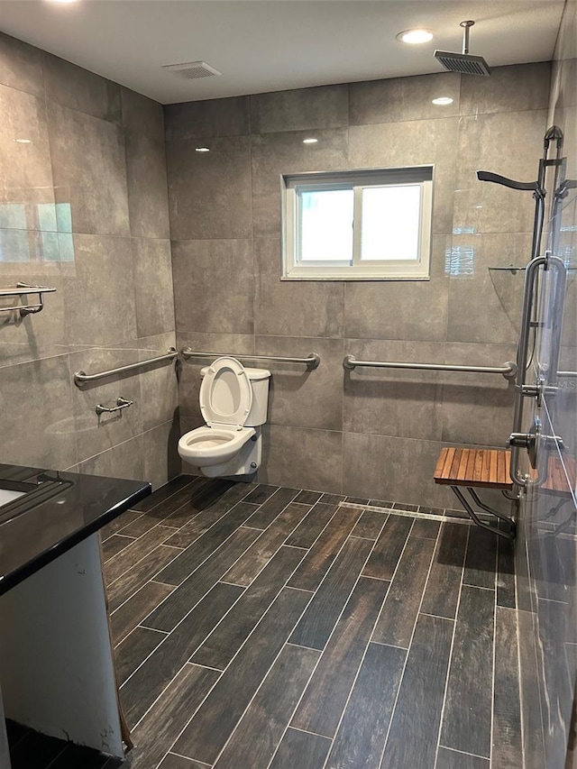 bathroom featuring walk in shower, vanity, and toilet