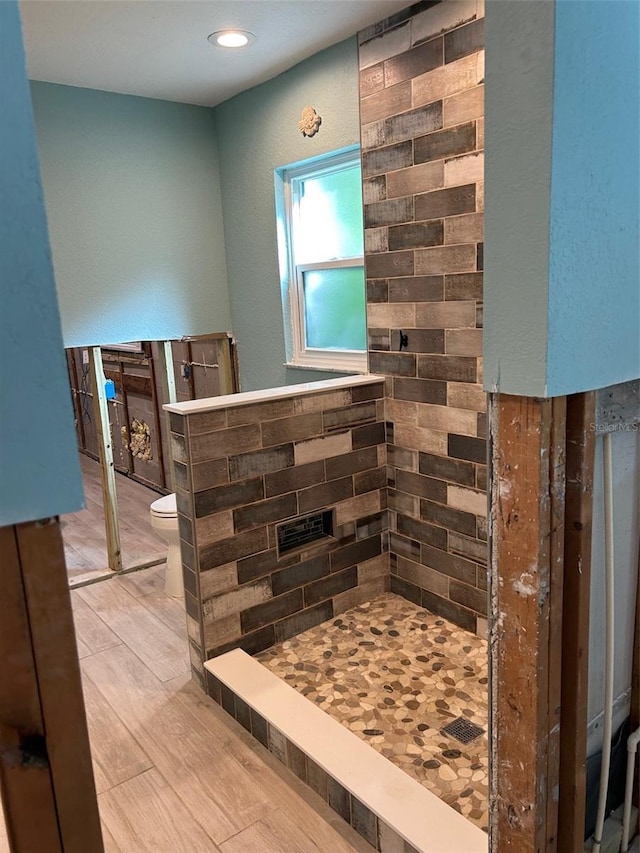 bathroom featuring wood-type flooring and toilet