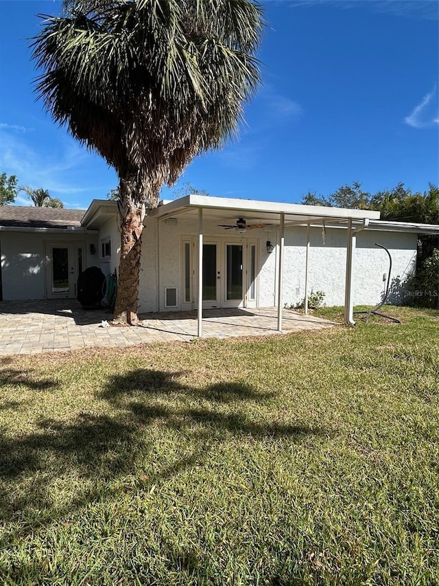 back of house with a yard, ceiling fan, and a patio area