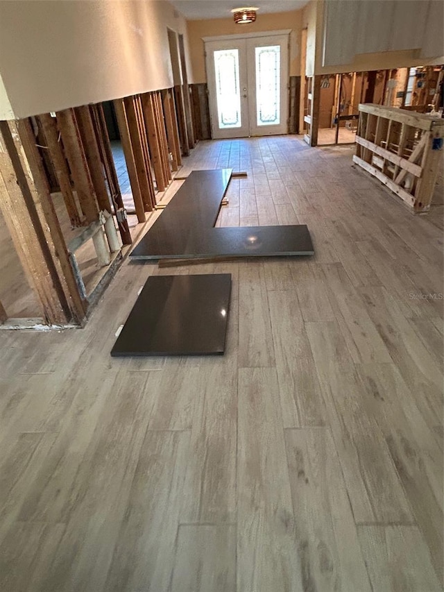 interior space with french doors and light wood-type flooring