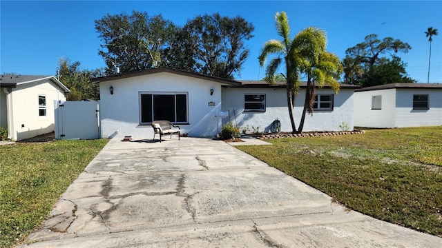 view of front of home with a patio and a front yard