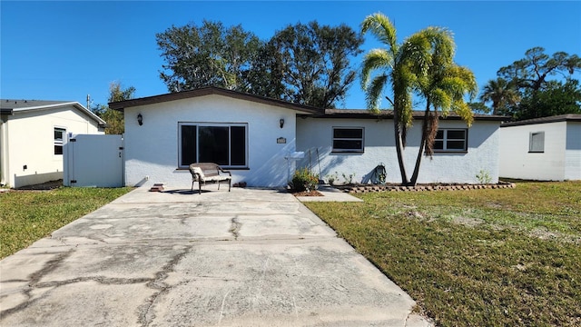 rear view of property with a yard and a patio