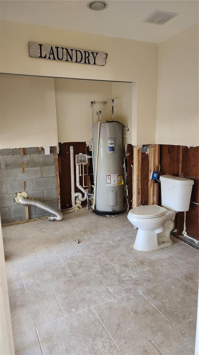 bathroom featuring water heater and toilet