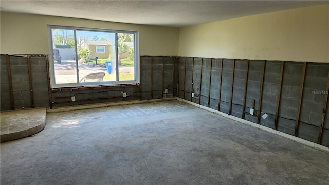 unfurnished room featuring concrete floors