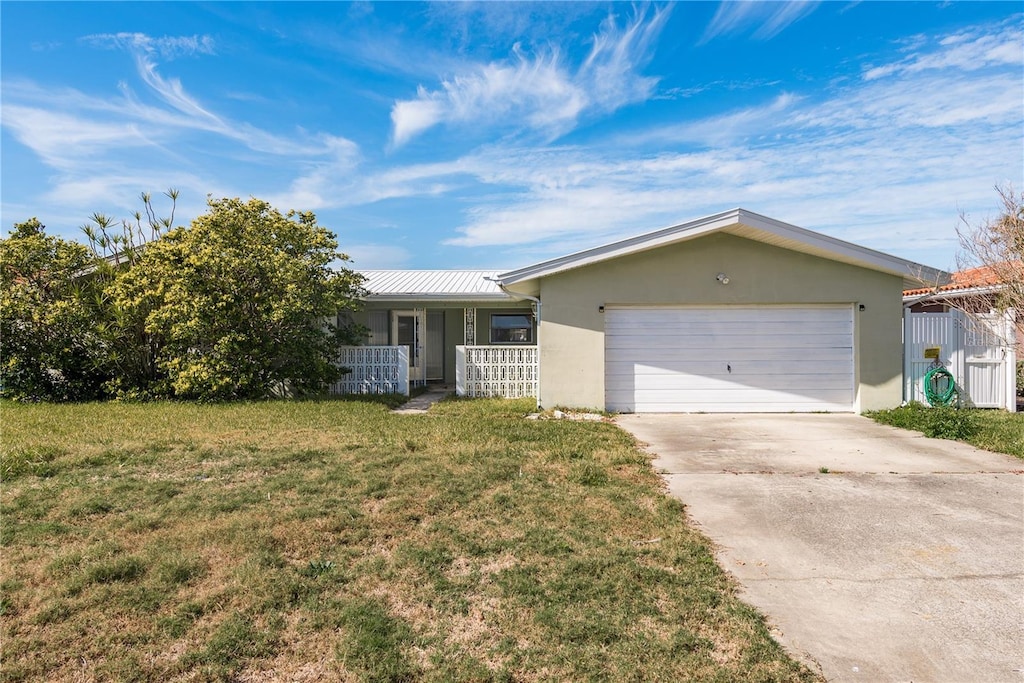 ranch-style home with a garage and a front yard