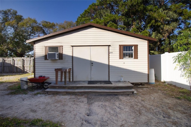 rear view of property with cooling unit