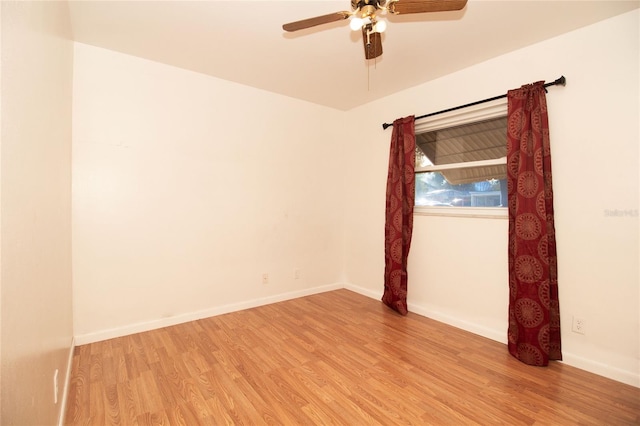 empty room with ceiling fan and light hardwood / wood-style floors