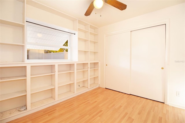 unfurnished bedroom featuring ceiling fan, wood-type flooring, and a closet