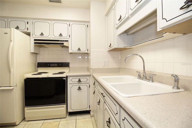 kitchen featuring sink, white cabinets, backsplash, light tile patterned floors, and white appliances