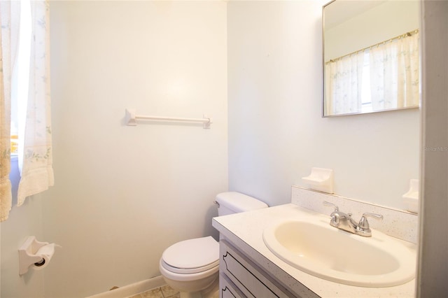 bathroom featuring vanity, tile patterned floors, and toilet